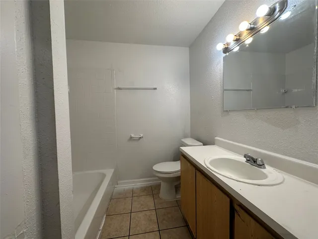 a bathroom with a sink a toilet and vanity