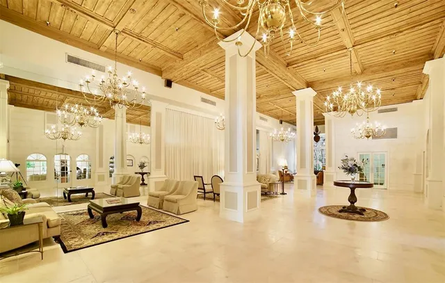 a living room with couches and pool view
