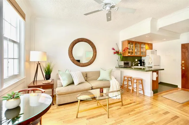a living room with furniture a mirror and a flat screen tv