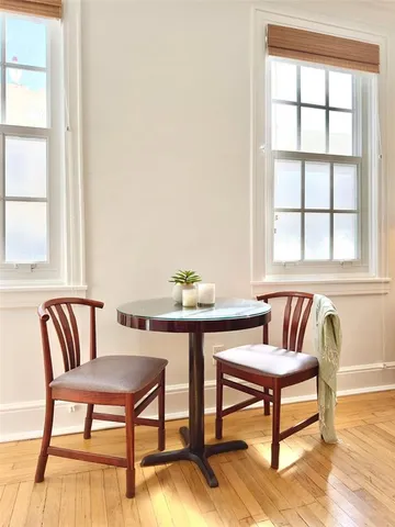 a view of a livingroom with furniture a rug and wooden floor