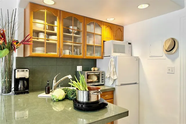 a kitchen with a refrigerator and a stove