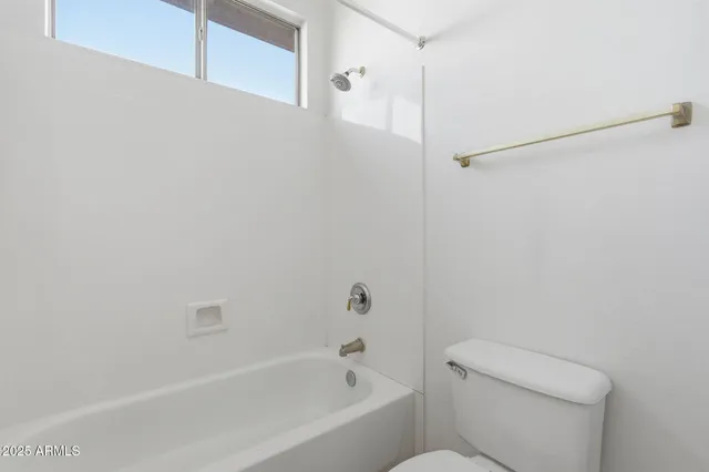 a bathroom with a bathtub and a toilet