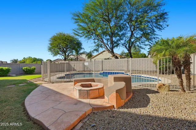 a view of a backyard with swimming pool