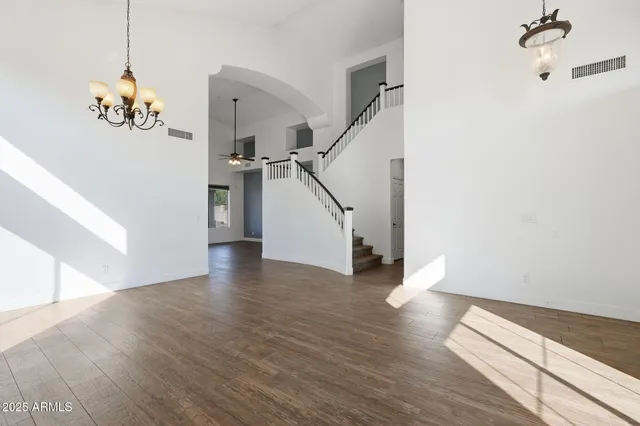 a view of a room with wooden floor and staircase