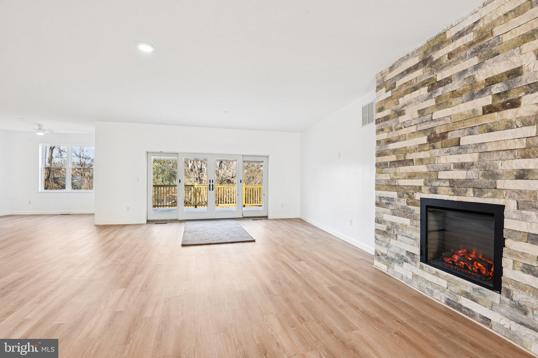 8325 Grove Angle Road Ellicott City, MD 21043 - Photo 11 of 72 an empty room with windows and fireplace