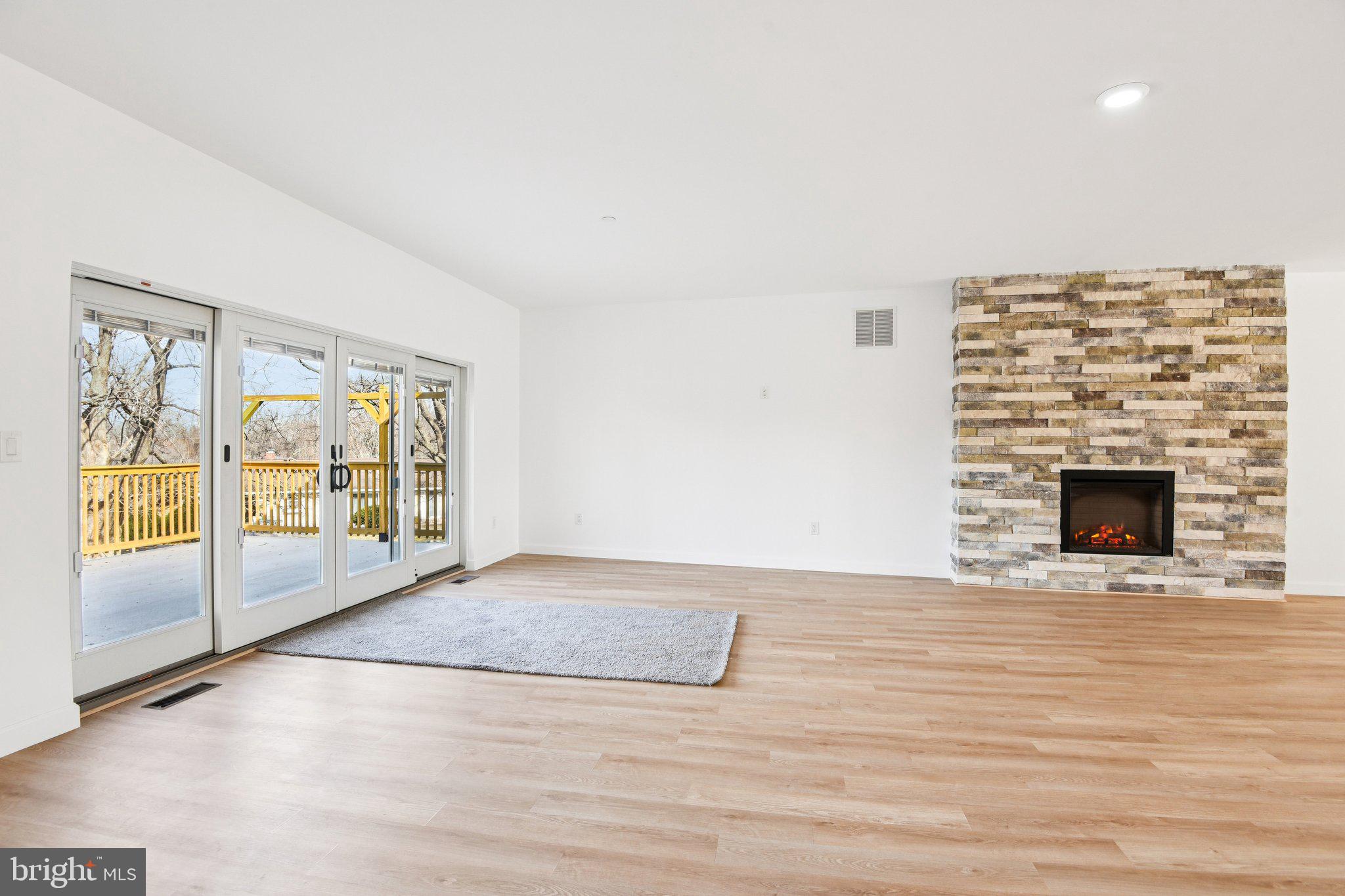 8325 Grove Angle Road Ellicott City, MD 21043 - Photo 12 of 72 a view of an empty room with glass door and a window