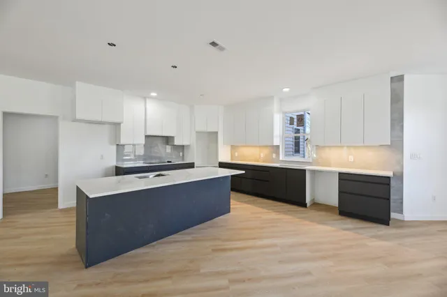a kitchen with a sink and cabinets