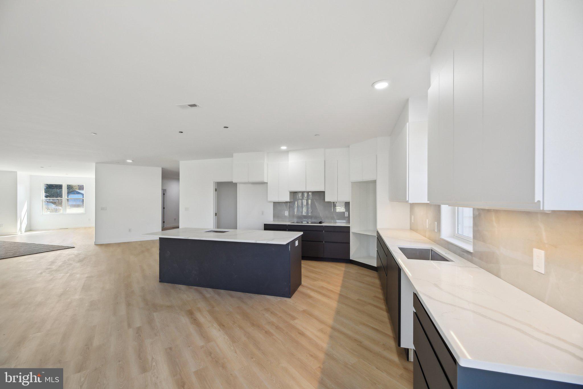 8325 Grove Angle Road Ellicott City, MD 21043 - Photo 13 of 57 a large kitchen with kitchen island a sink stainless steel appliances and cabinets
