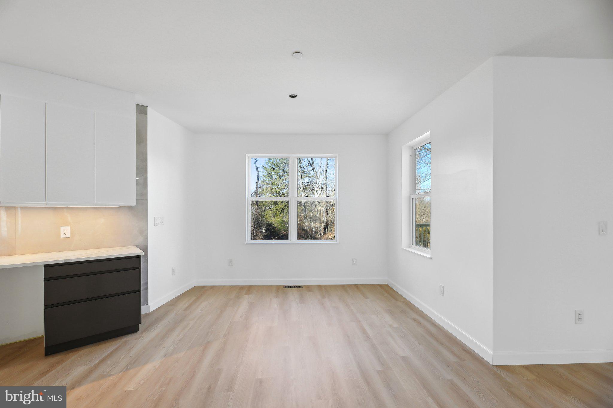 8325 Grove Angle Road Ellicott City, MD 21043 - Photo 15 of 57 an empty room with wooden floor and windows