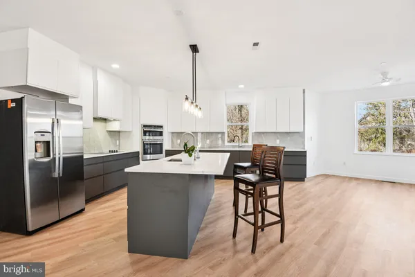a kitchen with a sink stove and refrigerator
