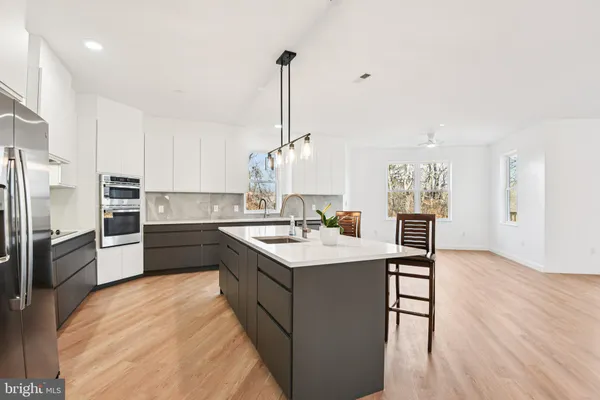 a kitchen with a sink a stove and cabinets