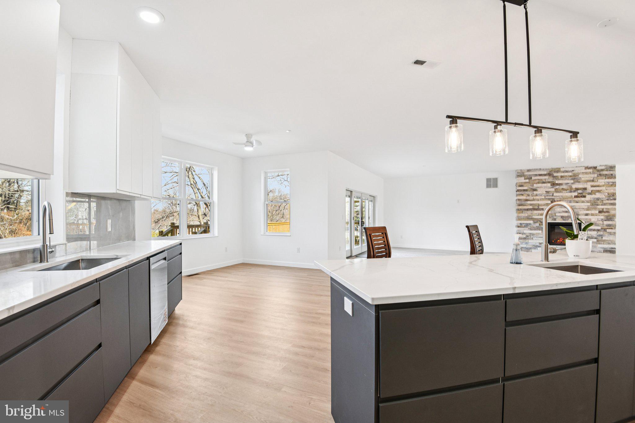 8325 Grove Angle Road Ellicott City, MD 21043 - Photo 18 of 72 a large kitchen with kitchen island a sink stainless steel appliances and a window