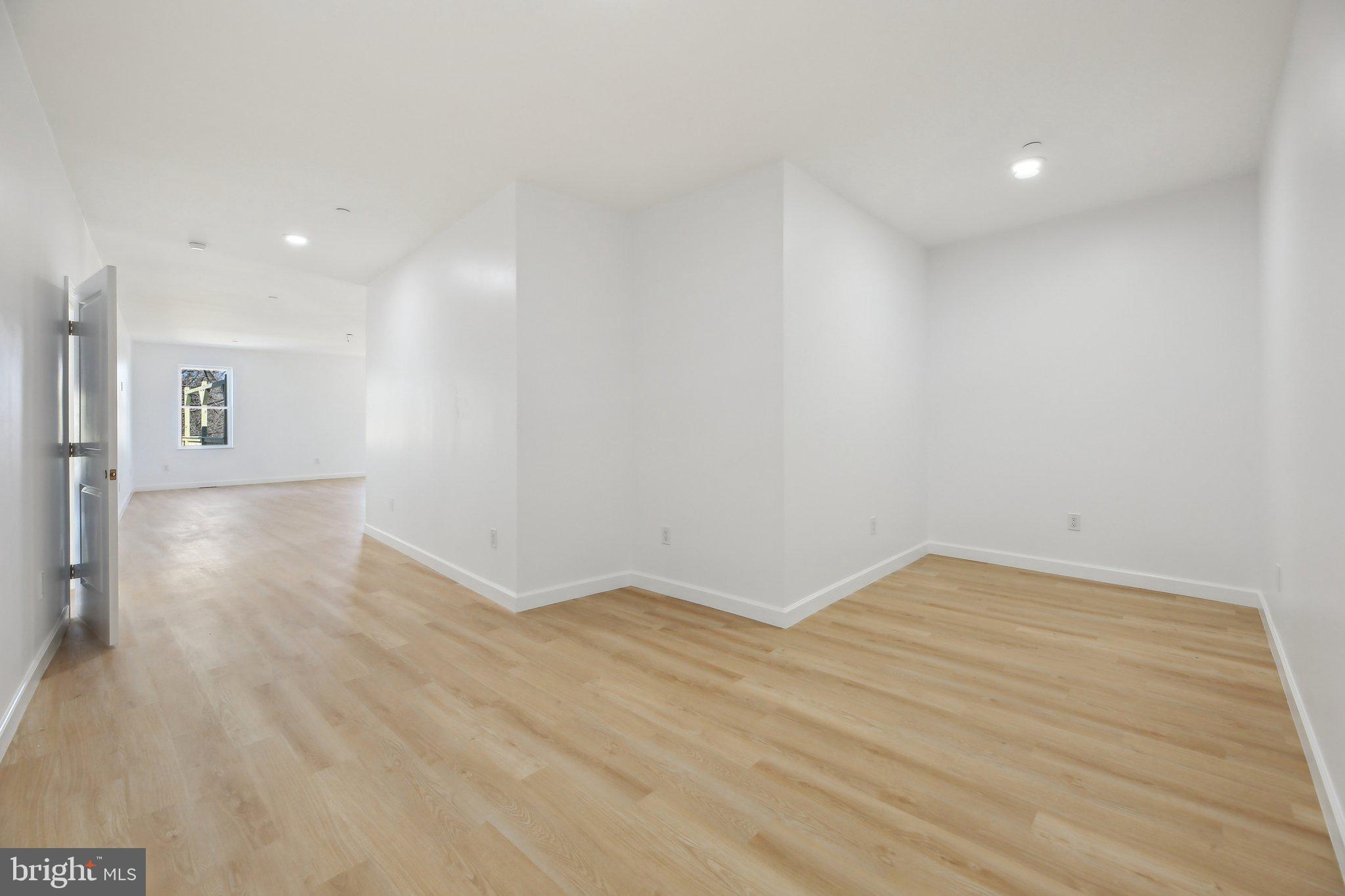 8325 Grove Angle Road Ellicott City, MD 21043 - Photo 24 of 57 a view of an empty room with wooden floor