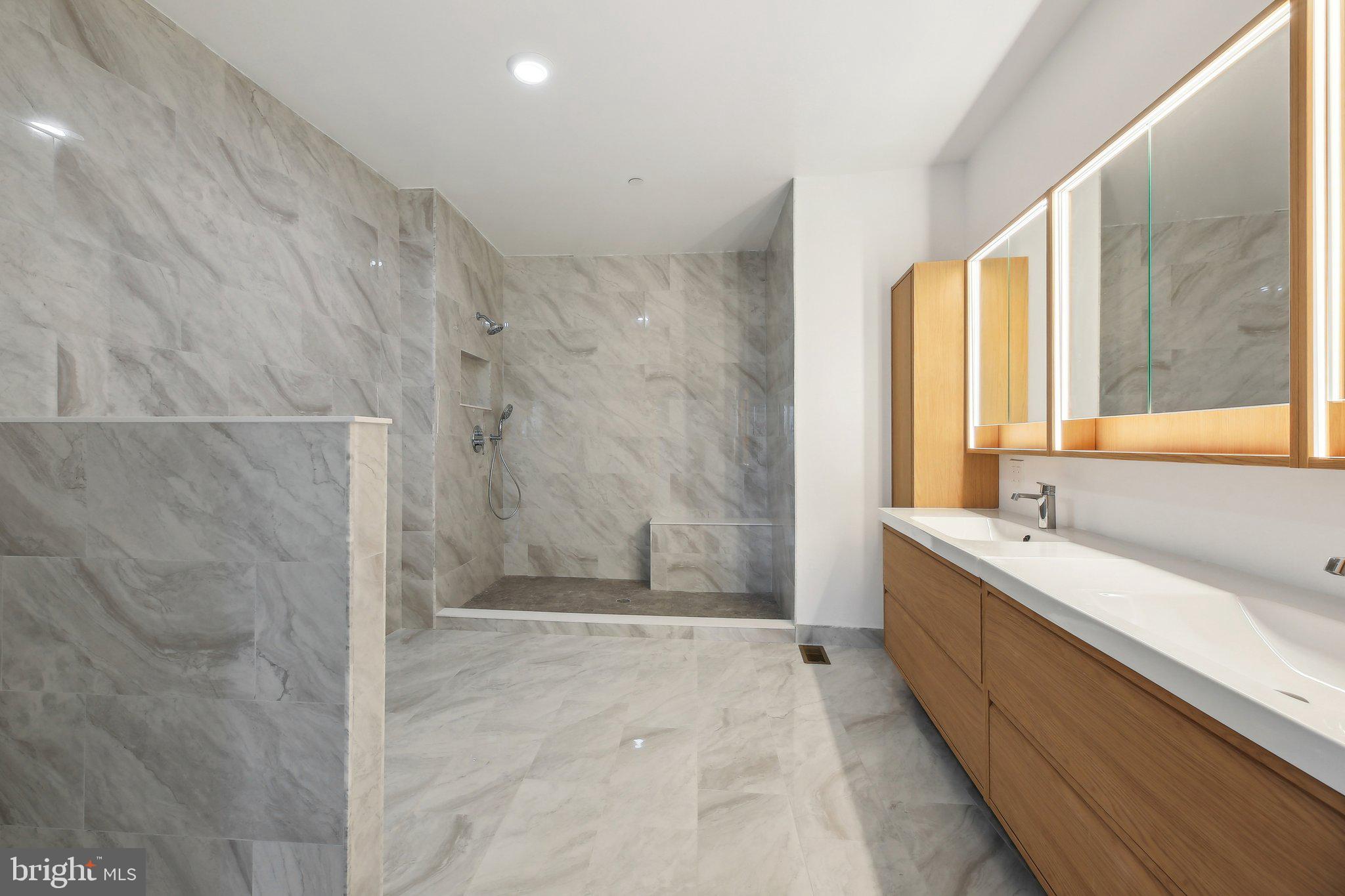 8325 Grove Angle Road Ellicott City, MD 21043 - Photo 25 of 57 a spacious bathroom with a tub sink and mirror