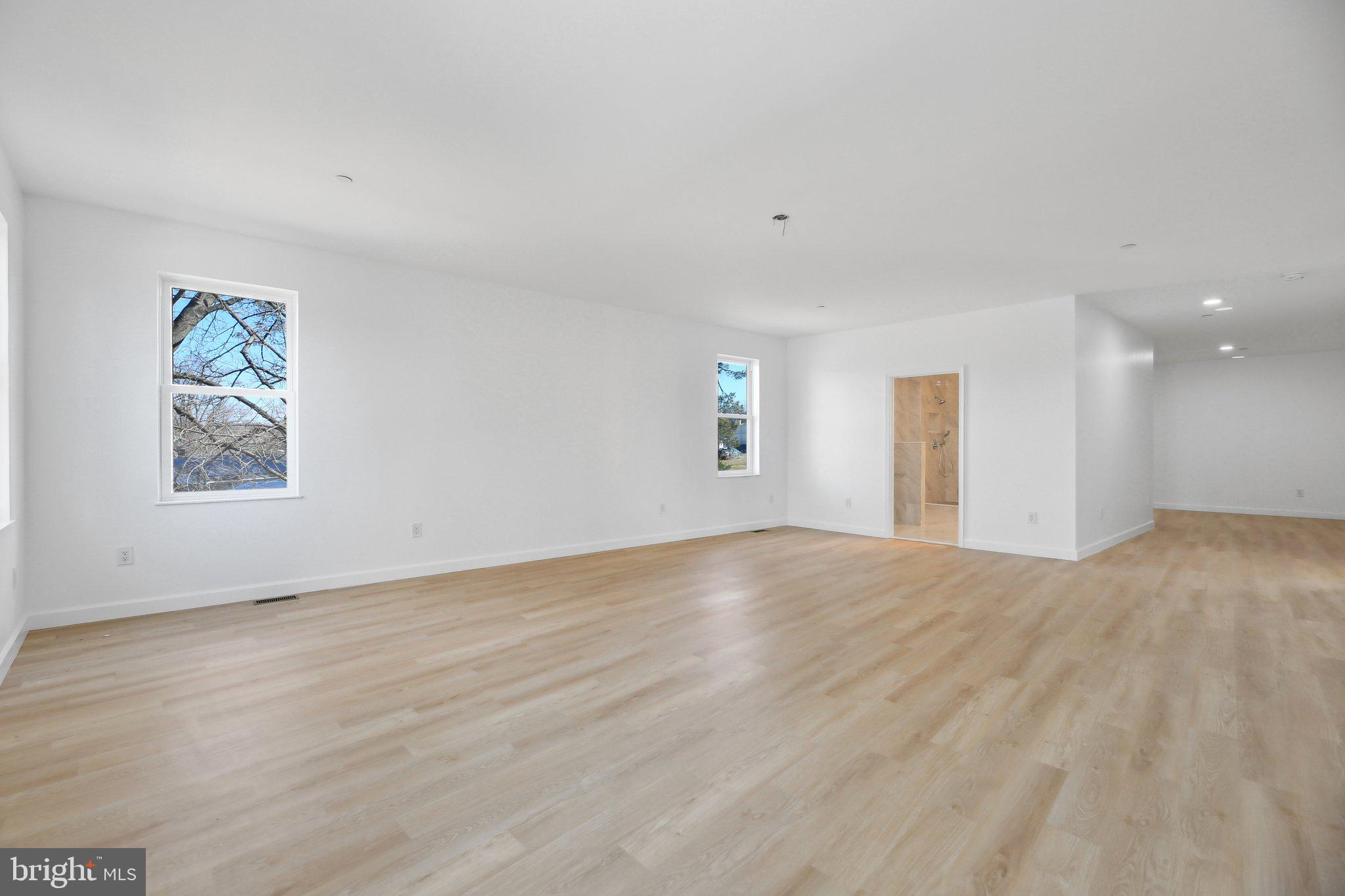 8325 Grove Angle Road Ellicott City, MD 21043 - Photo 26 of 72 a view of an empty room with wooden floor and a window