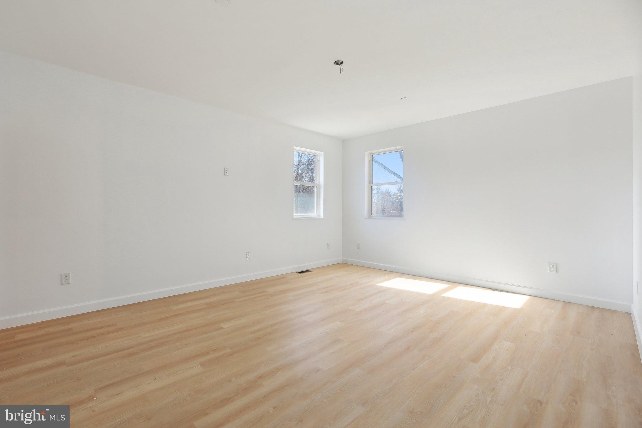 8325 Grove Angle Road Ellicott City, MD 21043 - Photo 29 of 57 a view of an empty room with wooden floor and a window