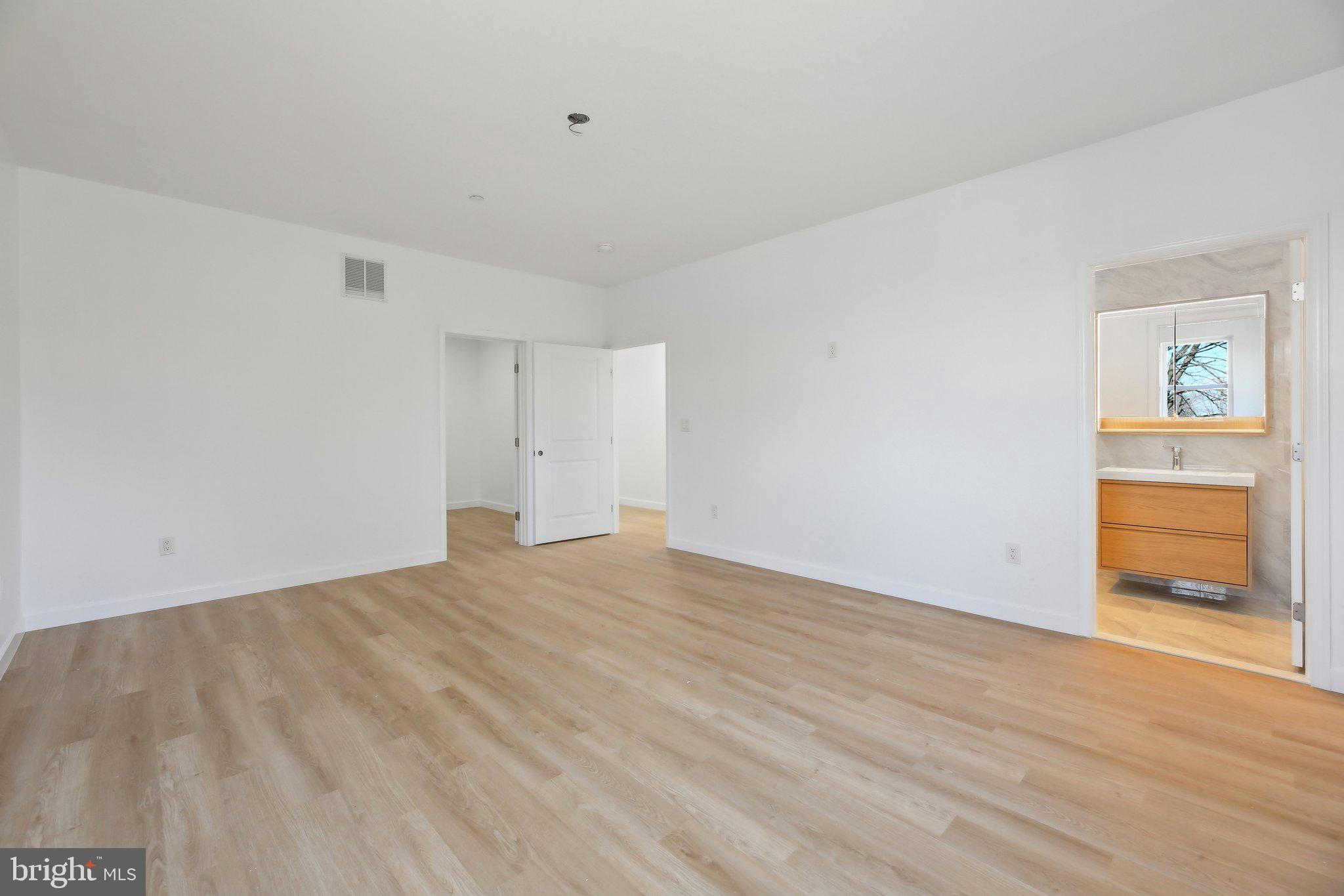 8325 Grove Angle Road Ellicott City, MD 21043 - Photo 33 of 57 a view of an empty room with wooden floor