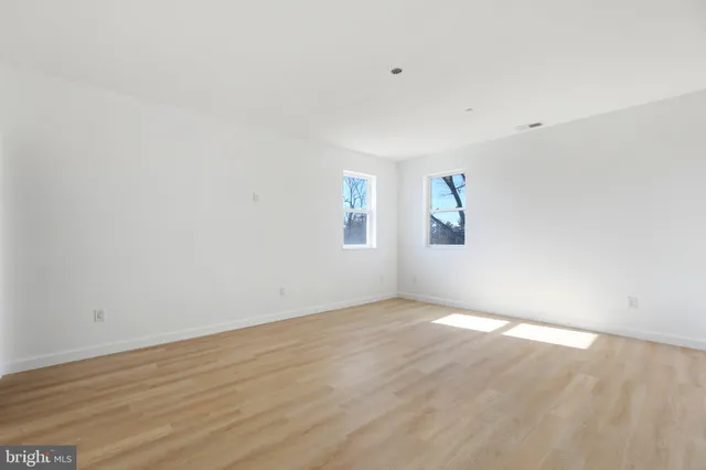 a view of a room with wooden floor and window