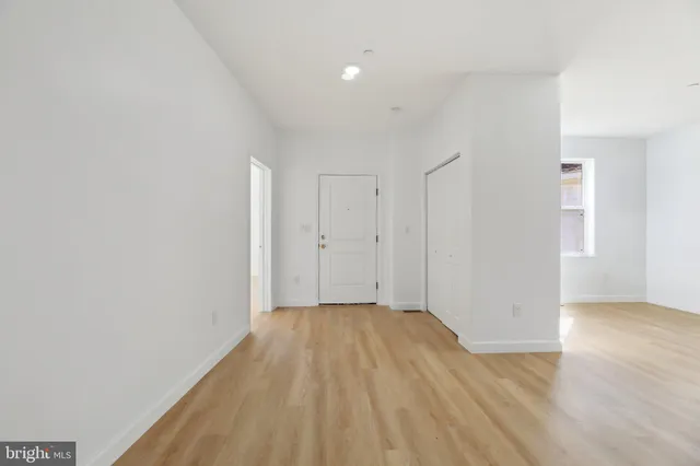 an empty room with a empty space and windows