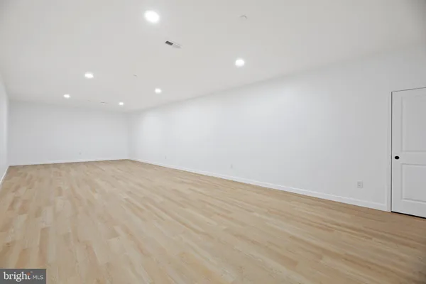 a view of a room with wooden floor and window