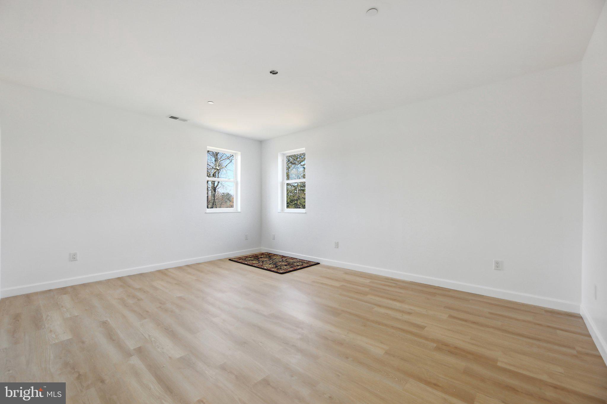 8325 Grove Angle Road Ellicott City, MD 21043 - Photo 51 of 72 a view of a room with wooden floor and window