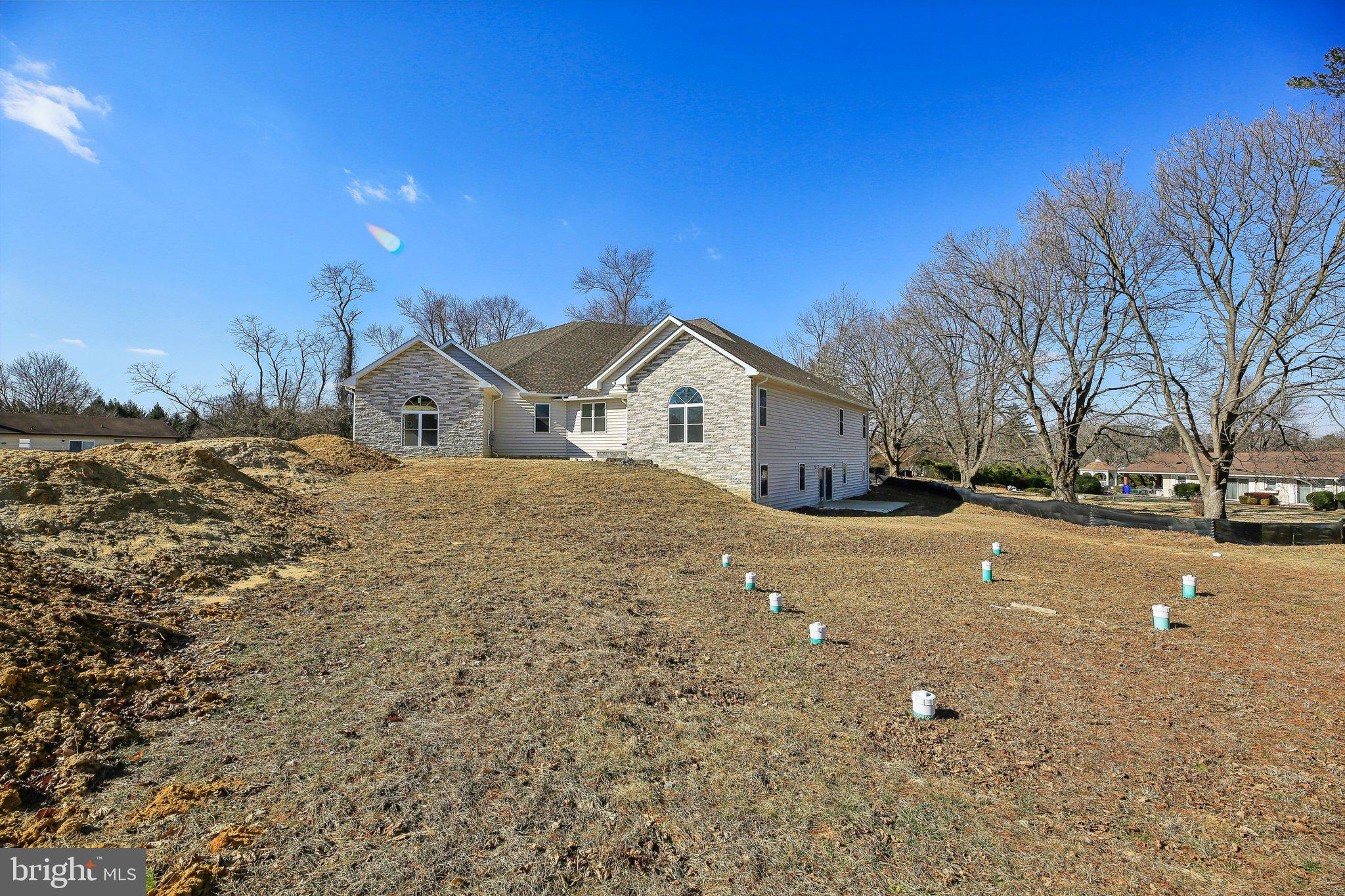 8325 Grove Angle Road Ellicott City, MD 21043 - Photo 51 of 57 a view of a house with a yard