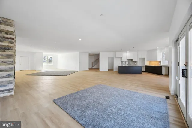 a view of an empty room with a fireplace and a window