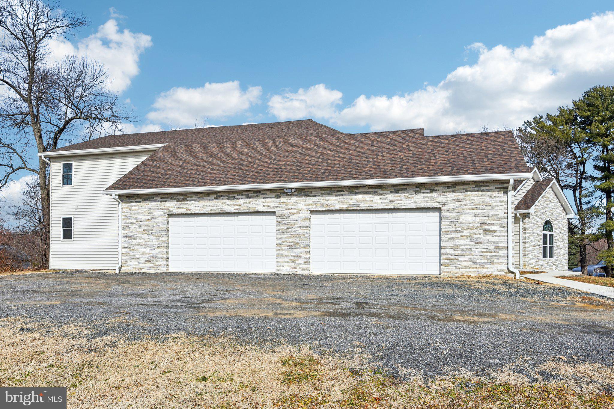 8325 Grove Angle Road Ellicott City, MD 21043 - Photo 62 of 72 a view of a house with a backyard and a garage