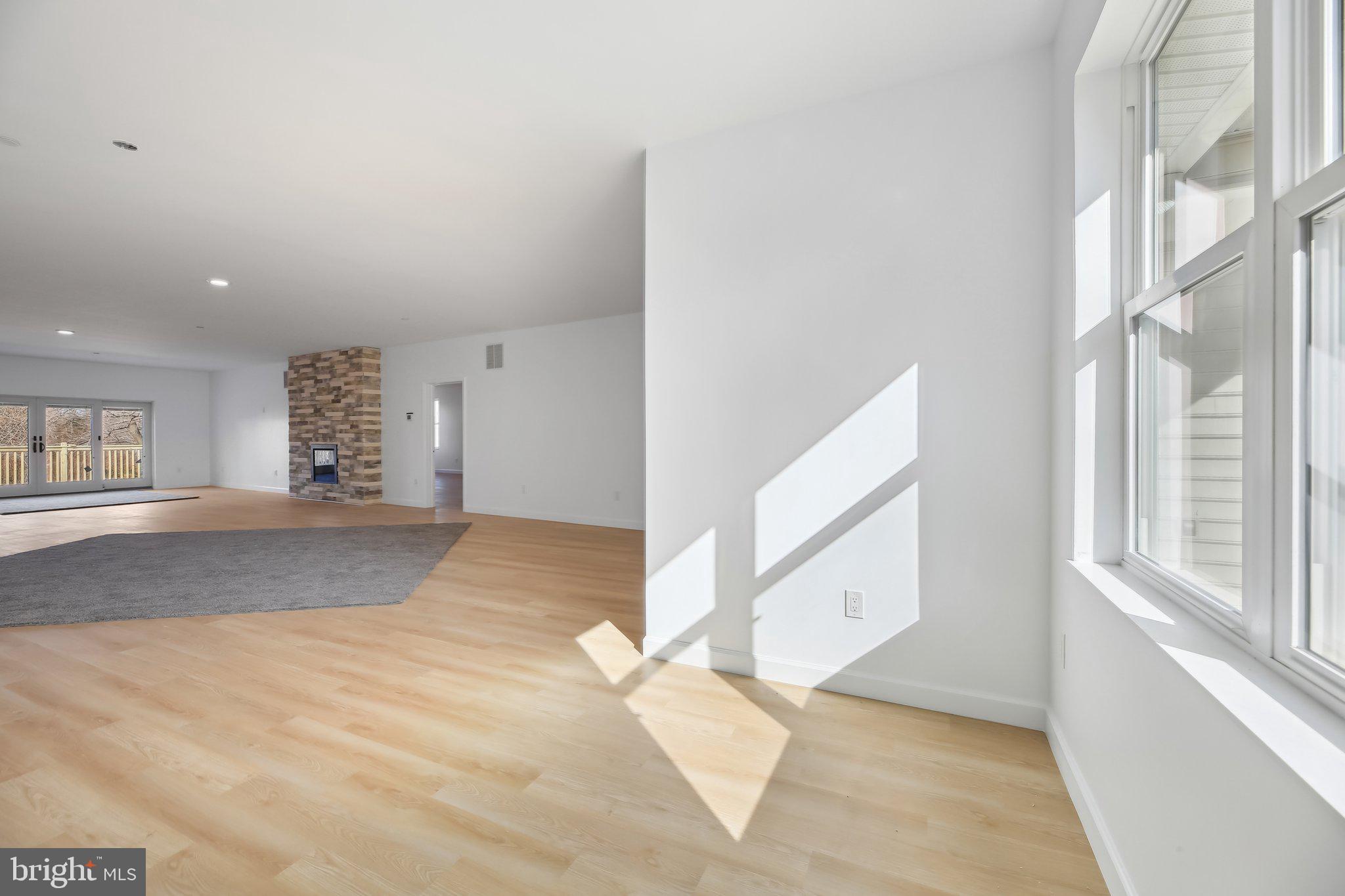 8325 Grove Angle Road Ellicott City, MD 21043 - Photo 7 of 57 a view of a big room with windows and chandelier