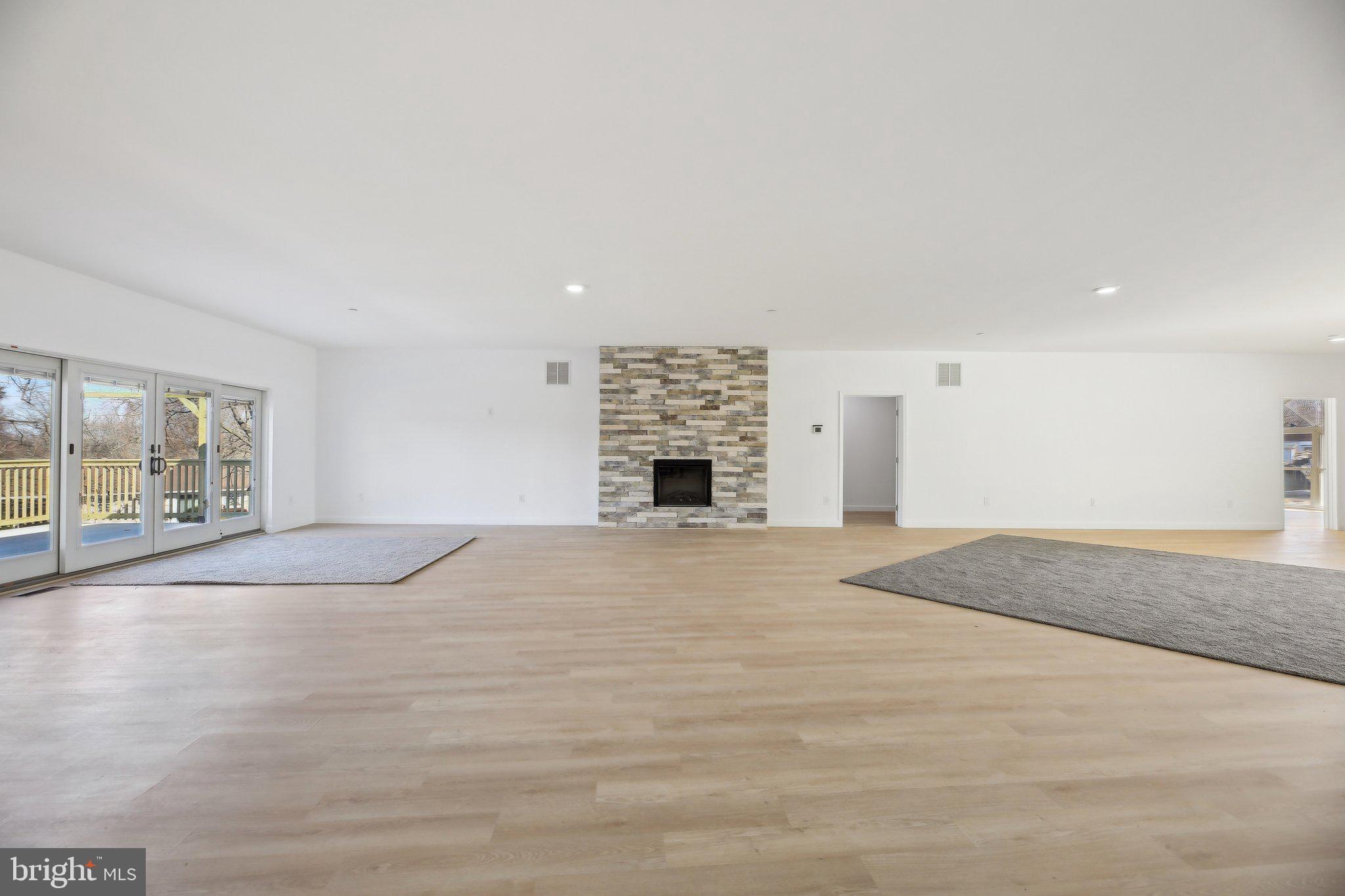 8325 Grove Angle Road Ellicott City, MD 21043 - Photo 8 of 57 a view of an empty room with a fireplace and a window