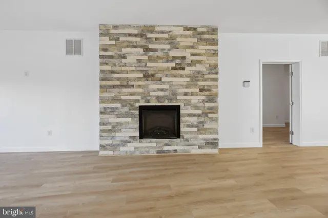 a view of kitchen with wooden floor and electronic appliances