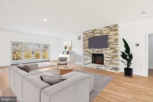 a living room with furniture a fireplace and a flat screen tv