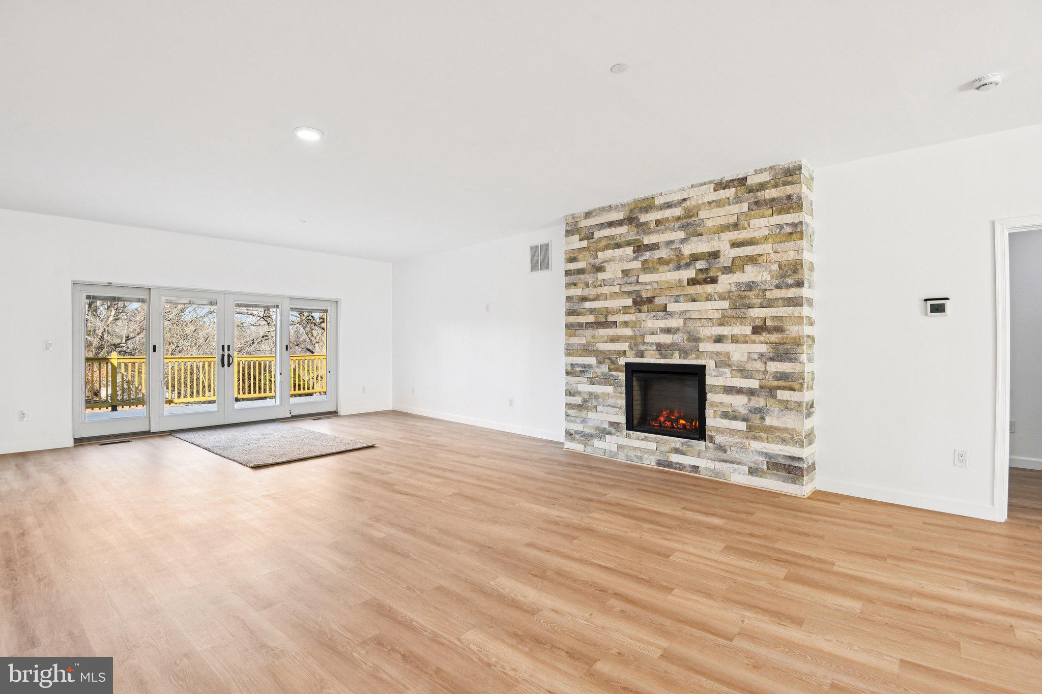 8325 Grove Angle Road Ellicott City, MD 21043 - Photo 10 of 72 a view of an empty room with a fireplace and a window