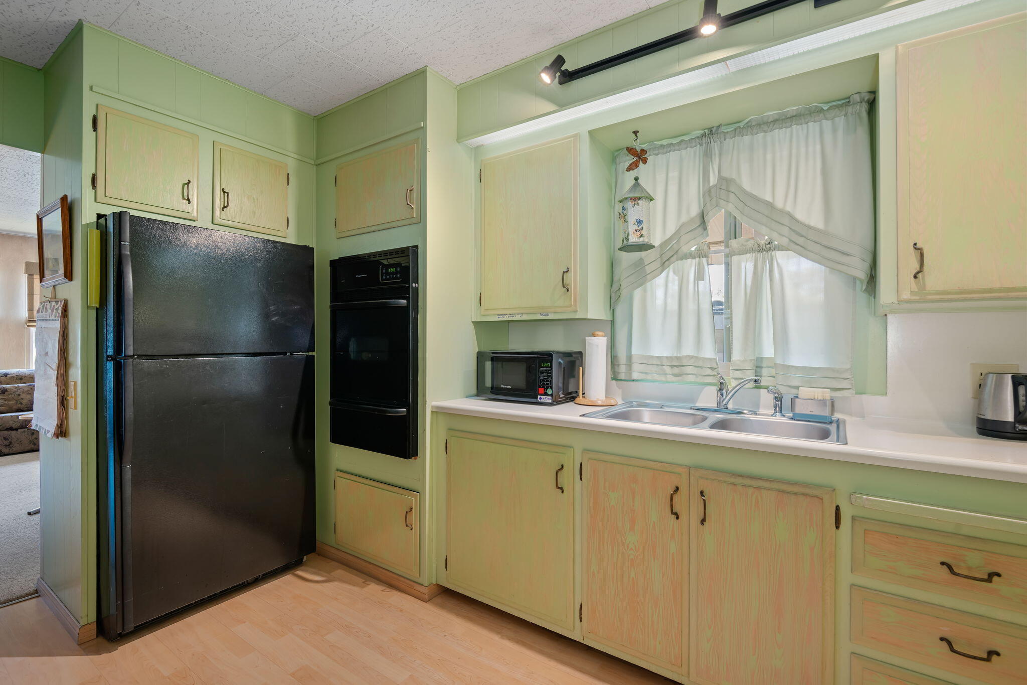 333 Old Mill Road, Unit 317 Santa Barbara, CA 93110 - Photo 6 of 12 a kitchen with a refrigerator and a sink