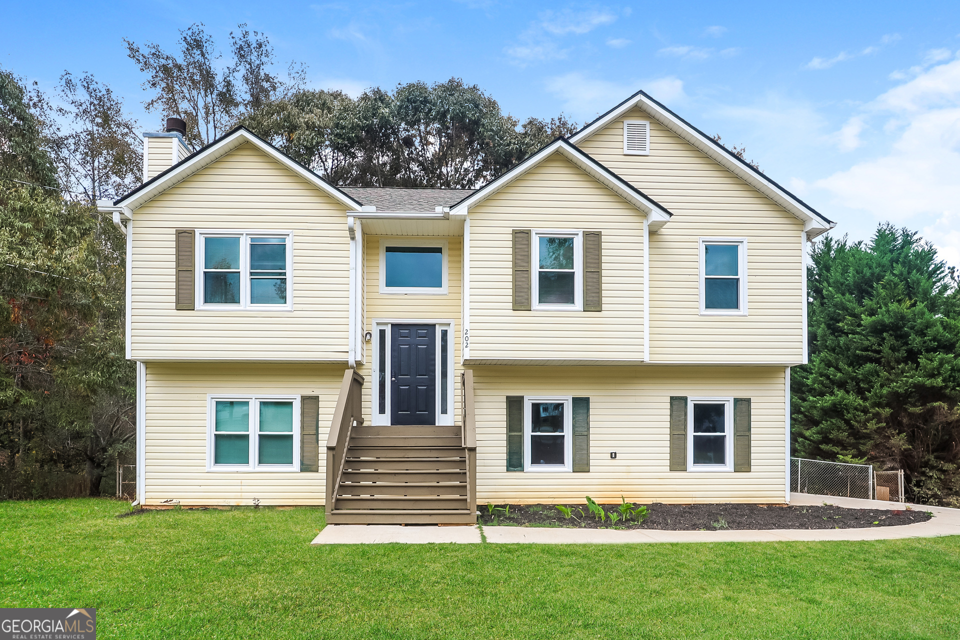 202 Wesley Mill Way Villa Rica, GA 30180 - Photo 1 of 17 a front view of a house with a yard