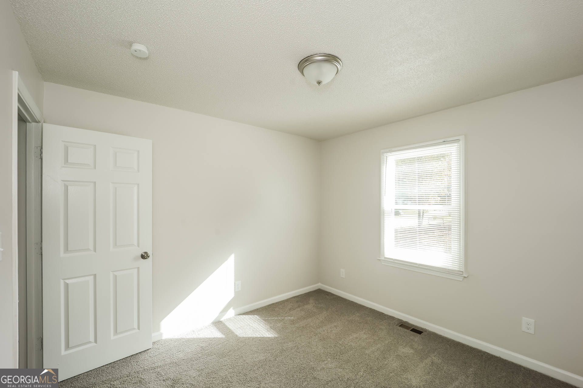 202 Wesley Mill Way Villa Rica, GA 30180 - Photo 13 of 17 an empty room with windows