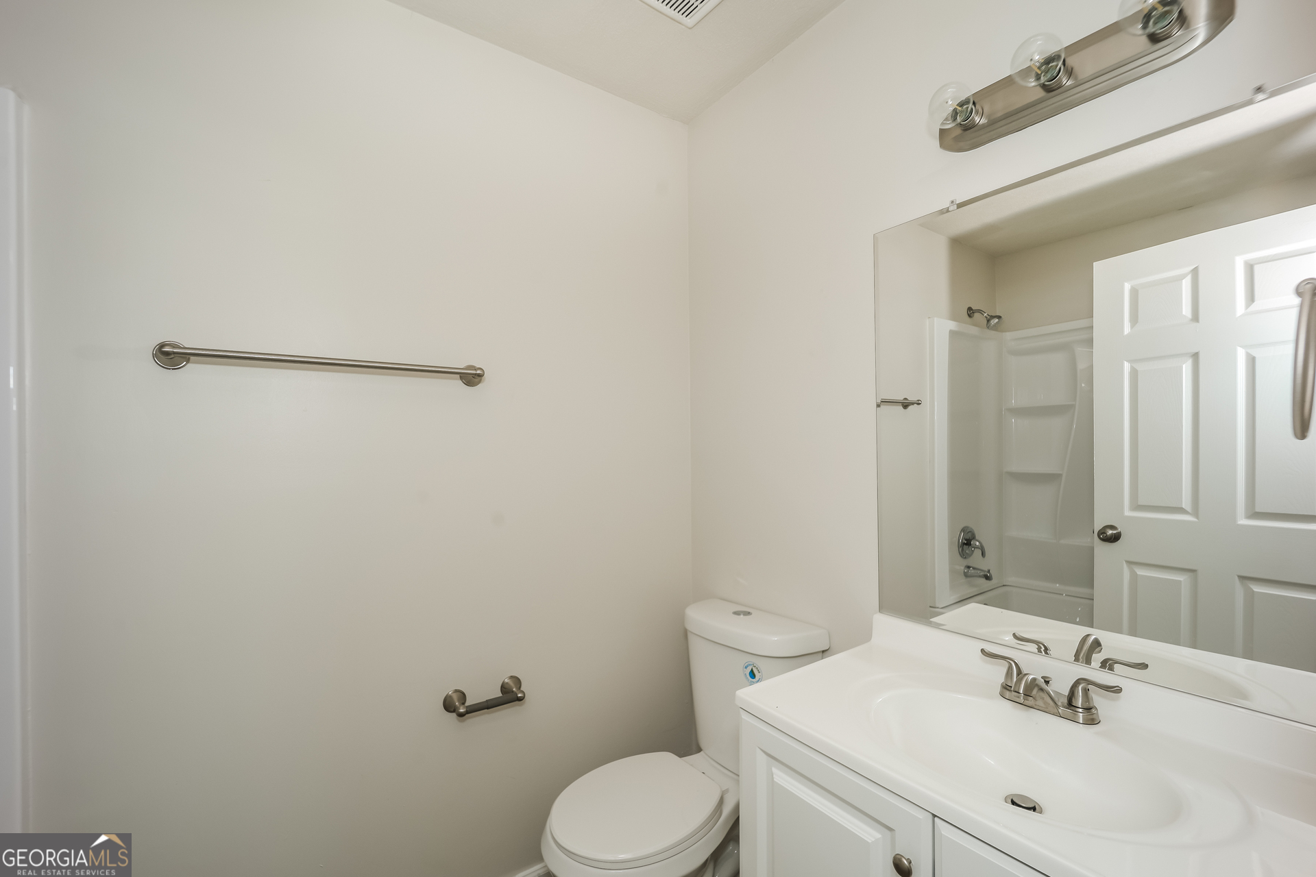 202 Wesley Mill Way Villa Rica, GA 30180 - Photo 14 of 17 a bathroom with a sink mirror and toilet