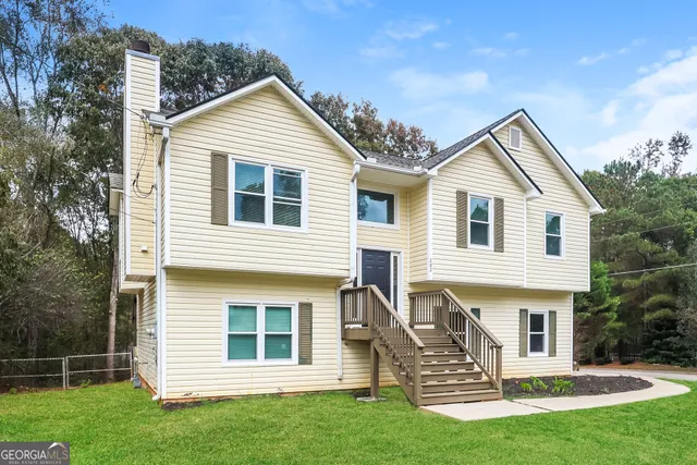 a front view of a house with a garden
