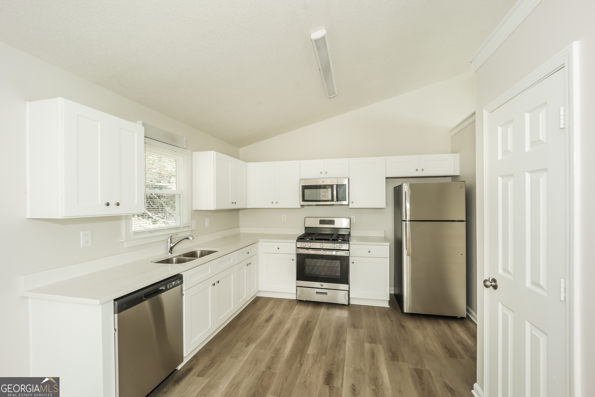 202 Wesley Mill Way Villa Rica, GA 30180 - Photo 7 of 17 a kitchen with cabinets and stainless steel appliances