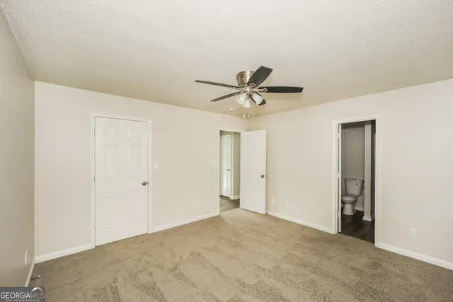 a view of a livingroom with a ceiling fan and window