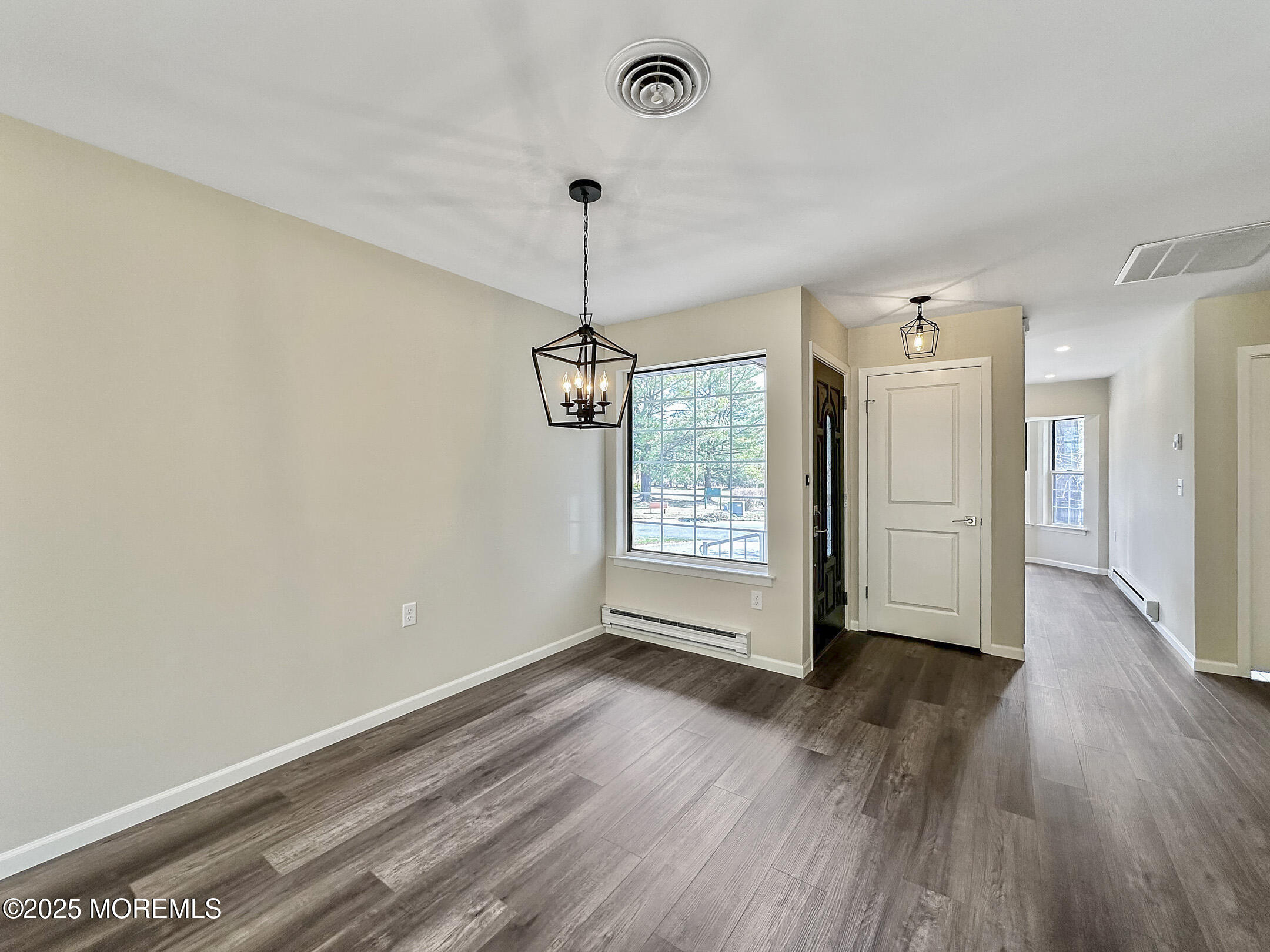 15D Alpine Road, Unit C Whiting, NJ 08759 - Photo 14 of 36 a view of an empty room with wooden floor and a window