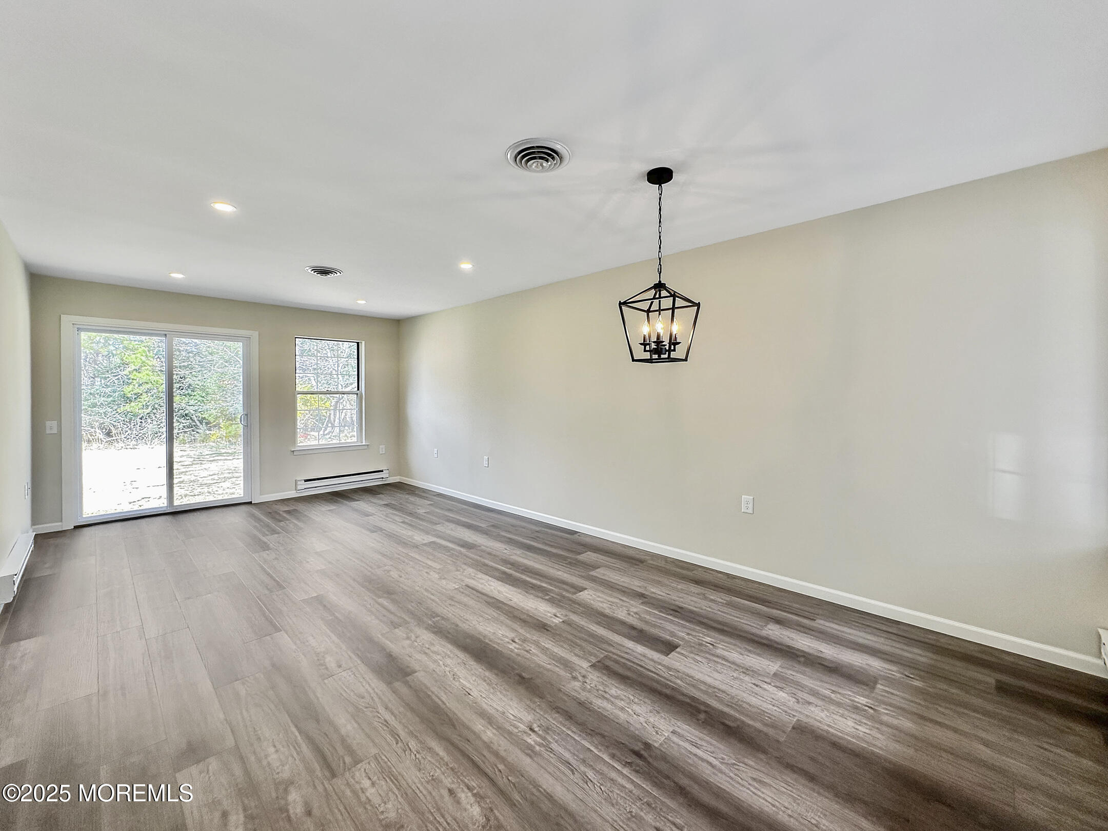 15D Alpine Road, Unit C Whiting, NJ 08759 - Photo 16 of 36 a view of an empty room with a window and wooden floor