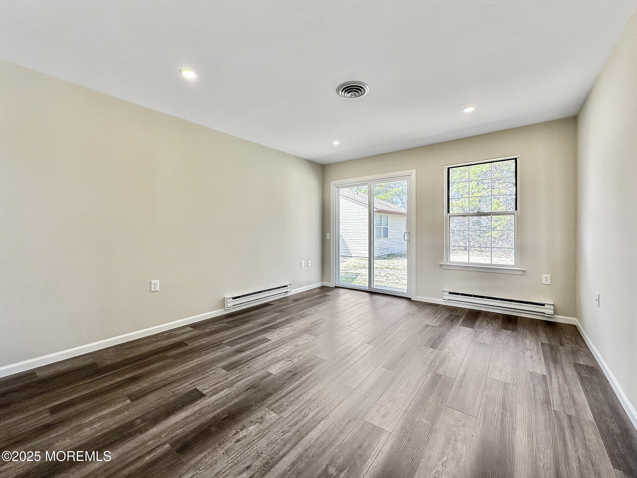 15D Alpine Road, Unit C Whiting, NJ 08759 - Photo 17 of 36 wooden floor in an empty room with a window