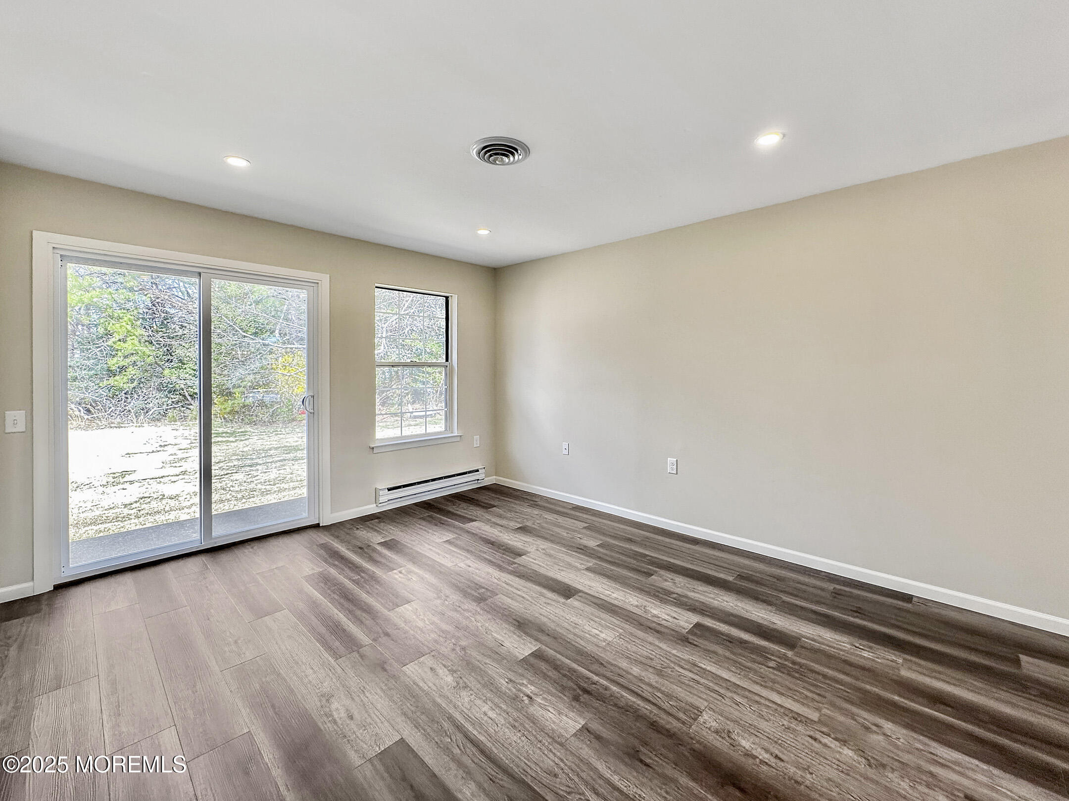 15D Alpine Road, Unit C Whiting, NJ 08759 - Photo 18 of 36 a view of an empty room with wooden floor and a window