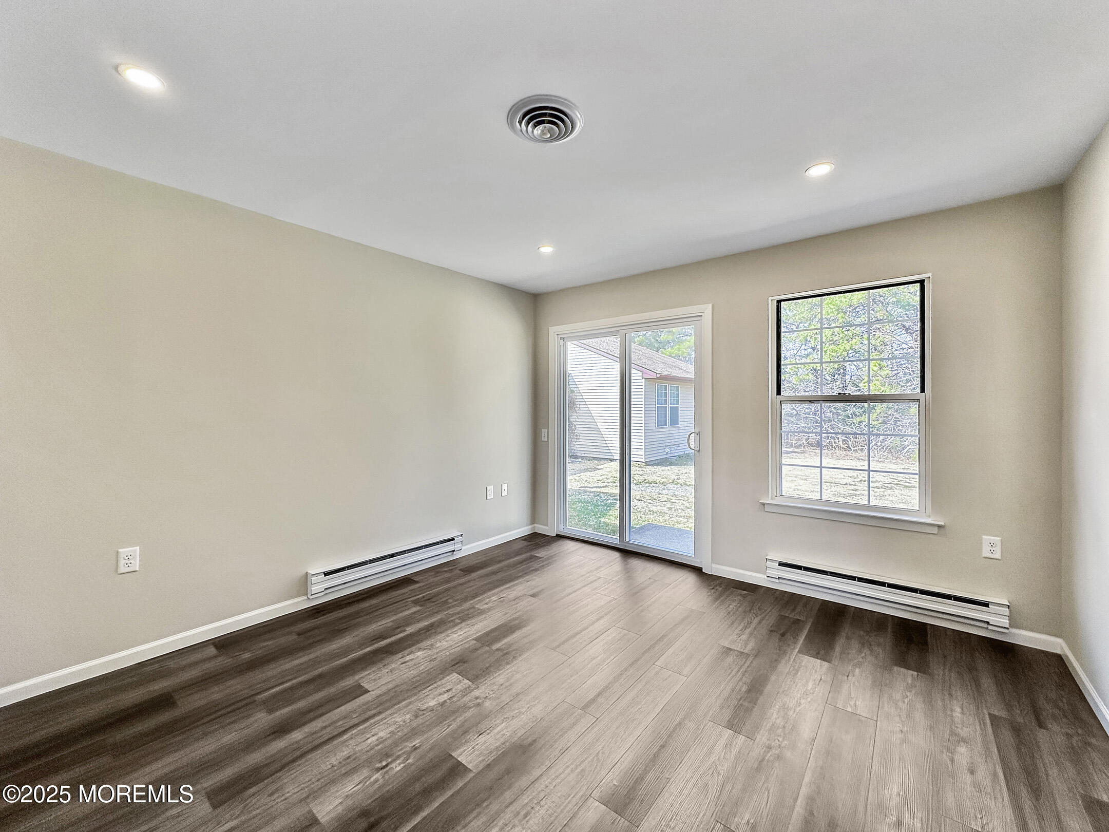 15D Alpine Road, Unit C Whiting, NJ 08759 - Photo 21 of 36 a view of an empty room with wooden floor and a window
