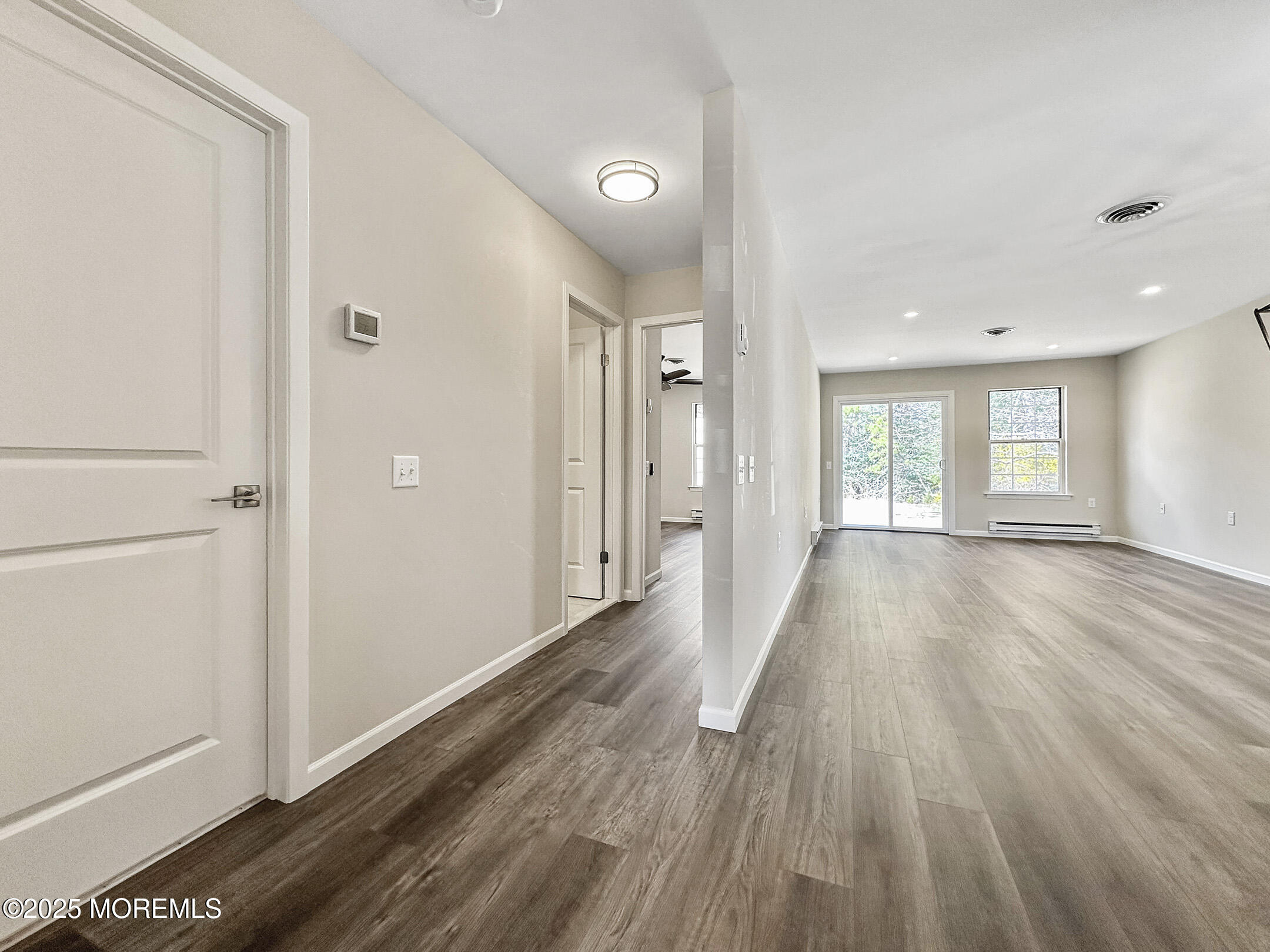 15D Alpine Road, Unit C Whiting, NJ 08759 - Photo 22 of 36 a view of an empty room with wooden floor and a window