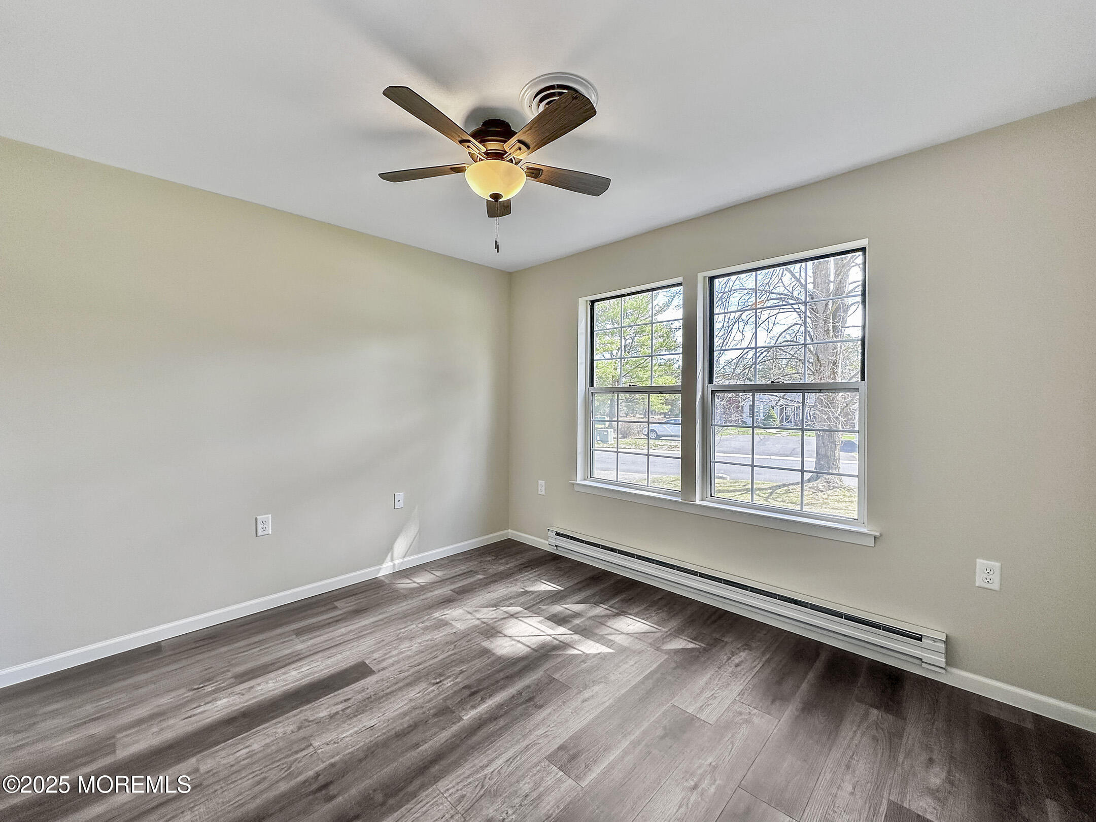 15D Alpine Road, Unit C Whiting, NJ 08759 - Photo 27 of 36 an empty room with wooden floor fan and windows