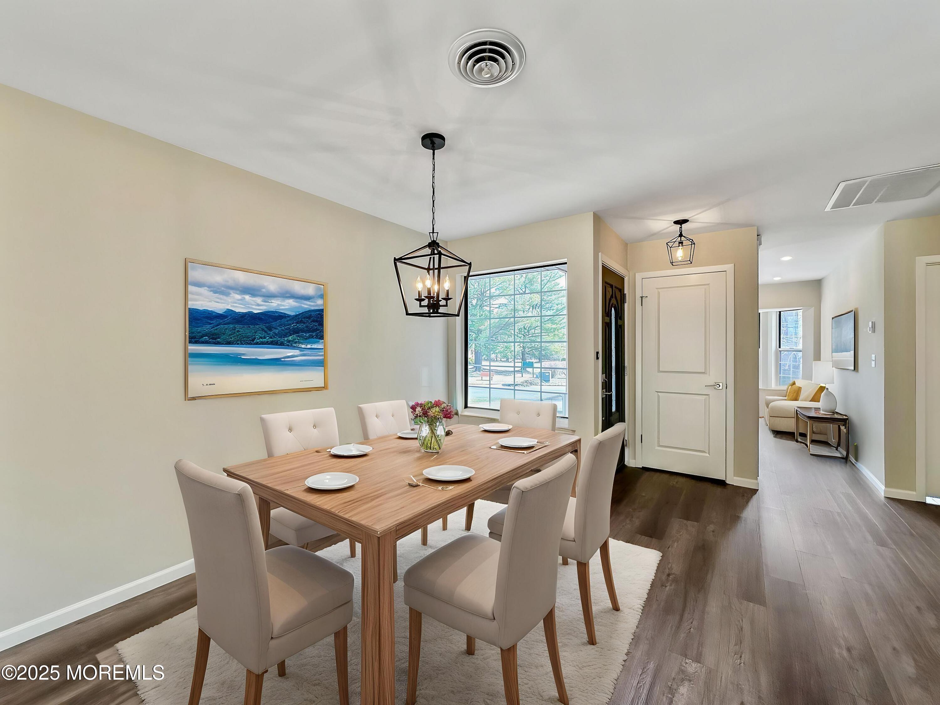 15D Alpine Road, Unit C Whiting, NJ 08759 - Photo 4 of 36 a view of a dining room with furniture wooden floor and chandelier