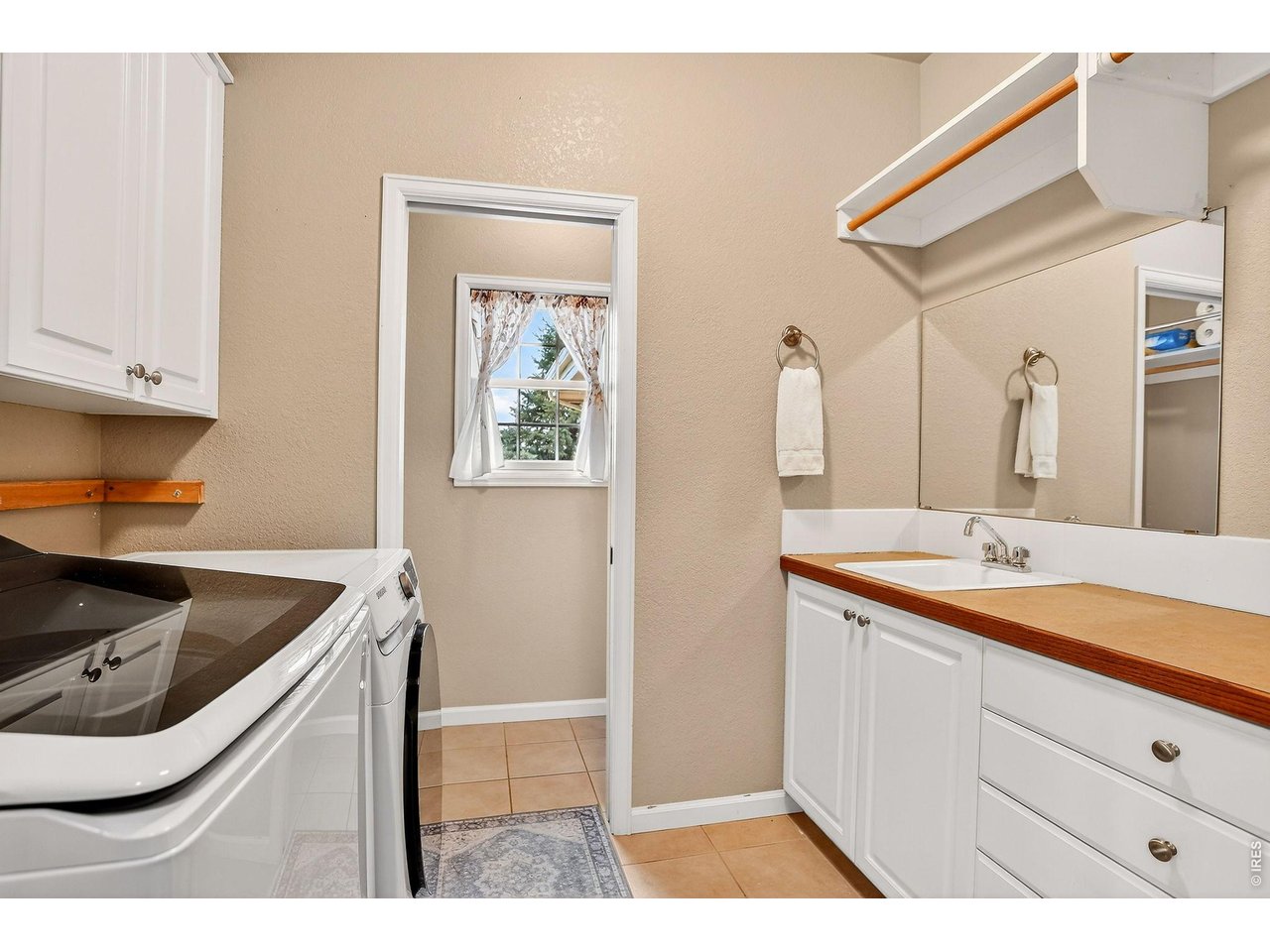 7514 19th St Road Greeley, CO 80634 - Photo 23 of 50 Laundry room with storage and 3/4 bath