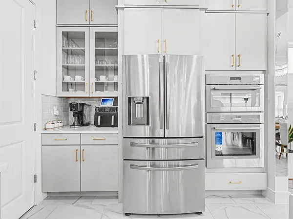 a kitchen with granite countertop cabinets and steel stainless steel appliances